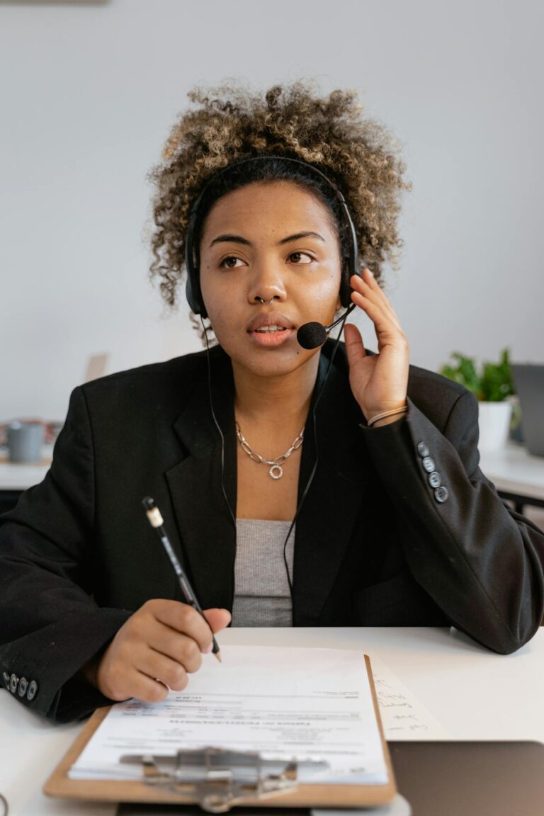 Woman with headset working in a call center environment.